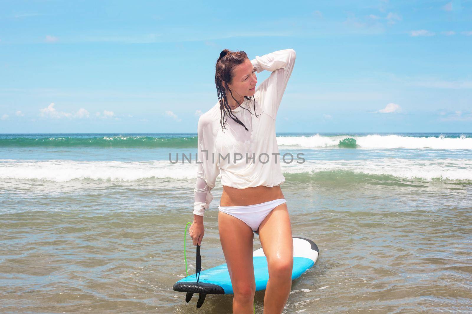 Girl on the waves with surfboard. by Jyliana