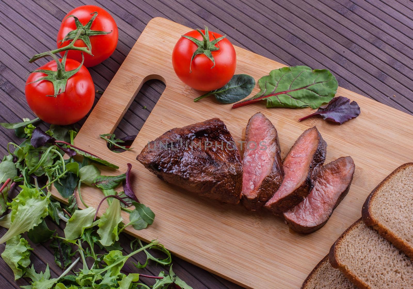 Beef grilled with blood on the kitchen blackboard. Stock image.