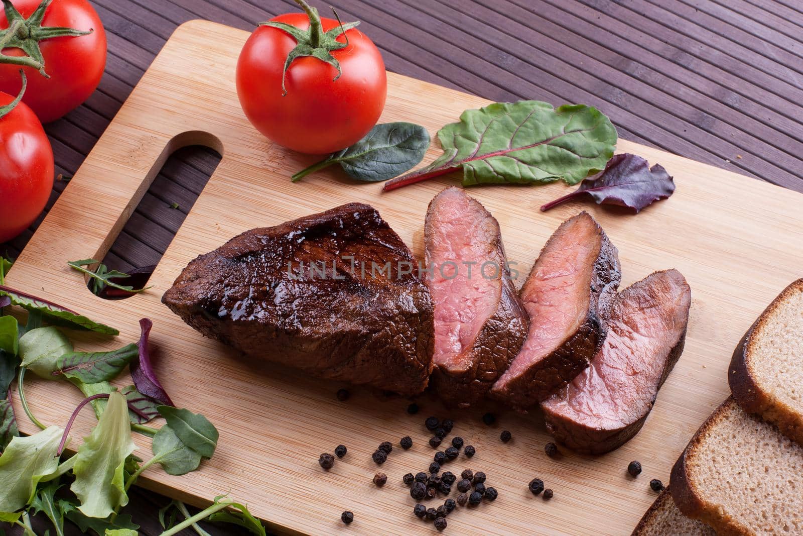 Beef grilled with blood on the kitchen blackboard. Stock image.