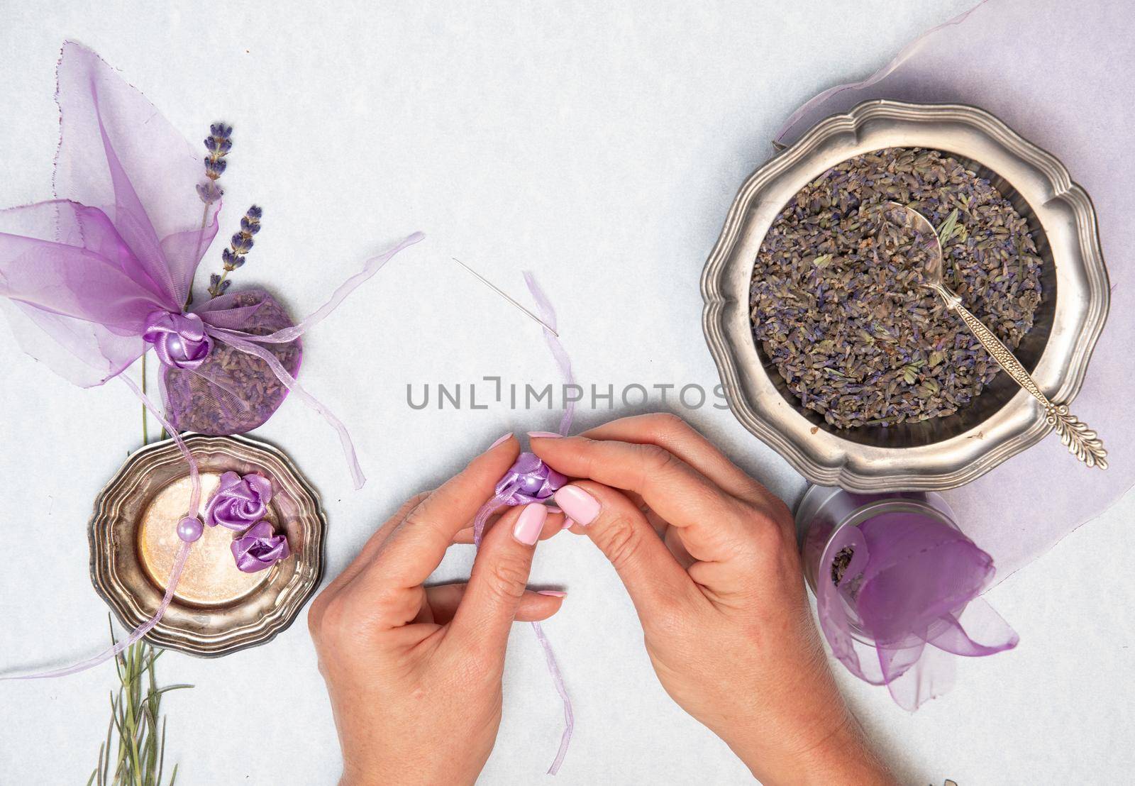dry lavender stems for making sachets in a beige tray on a wooden table top view, Bouquet of purple flowers, Flat lay, top view, natural soothing aromatherapy,high quality photo