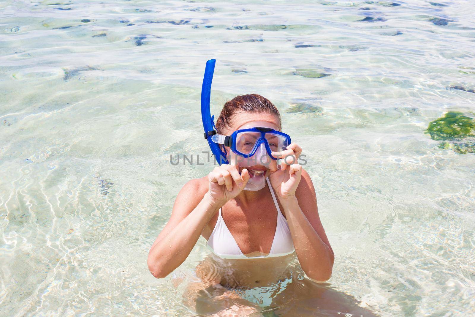 Happy woman on the beach with a diving mask. Bali, Indonesia. Stock image.