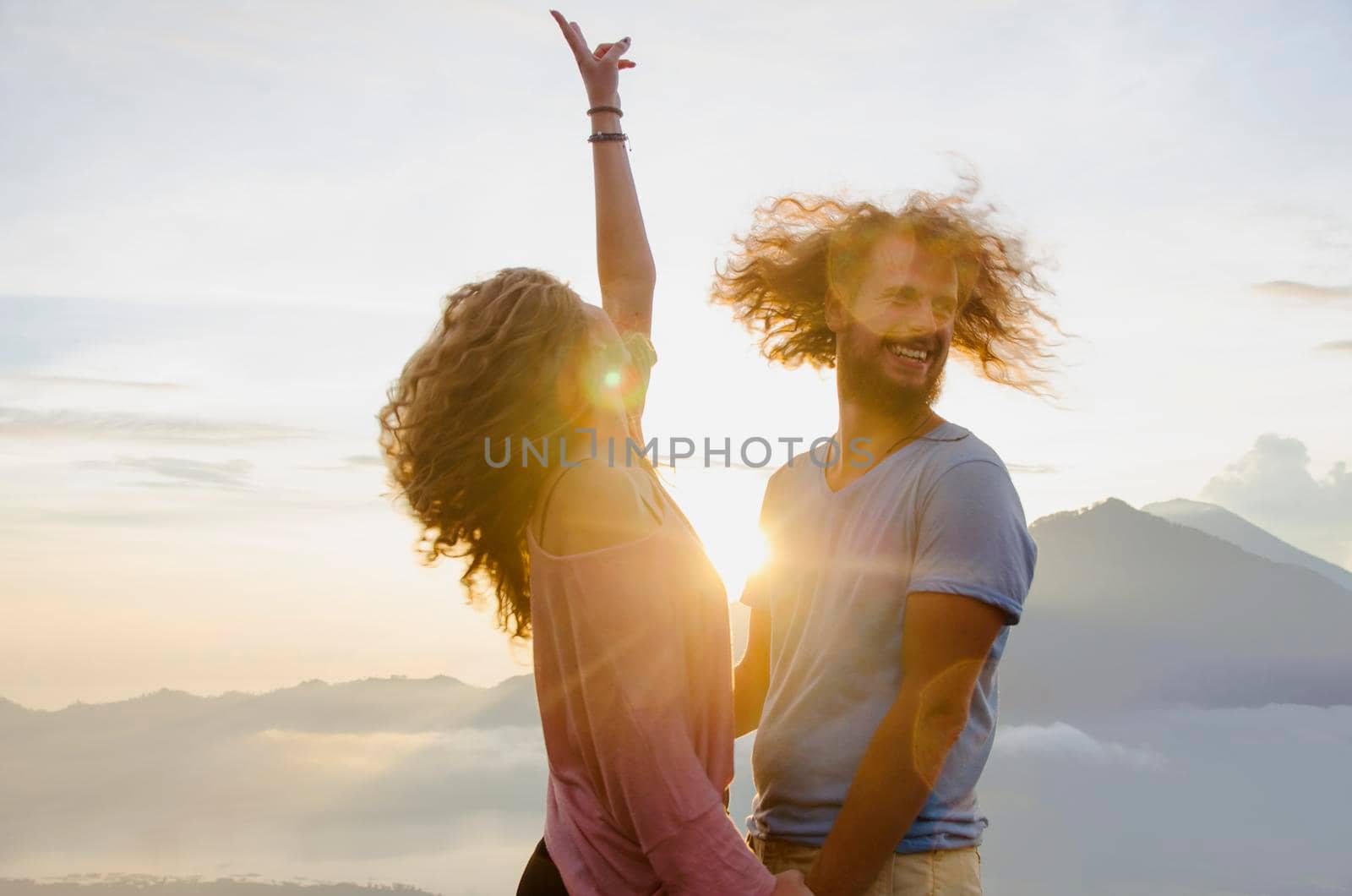 Happy couple in the sun on a background of mountains. stock image.