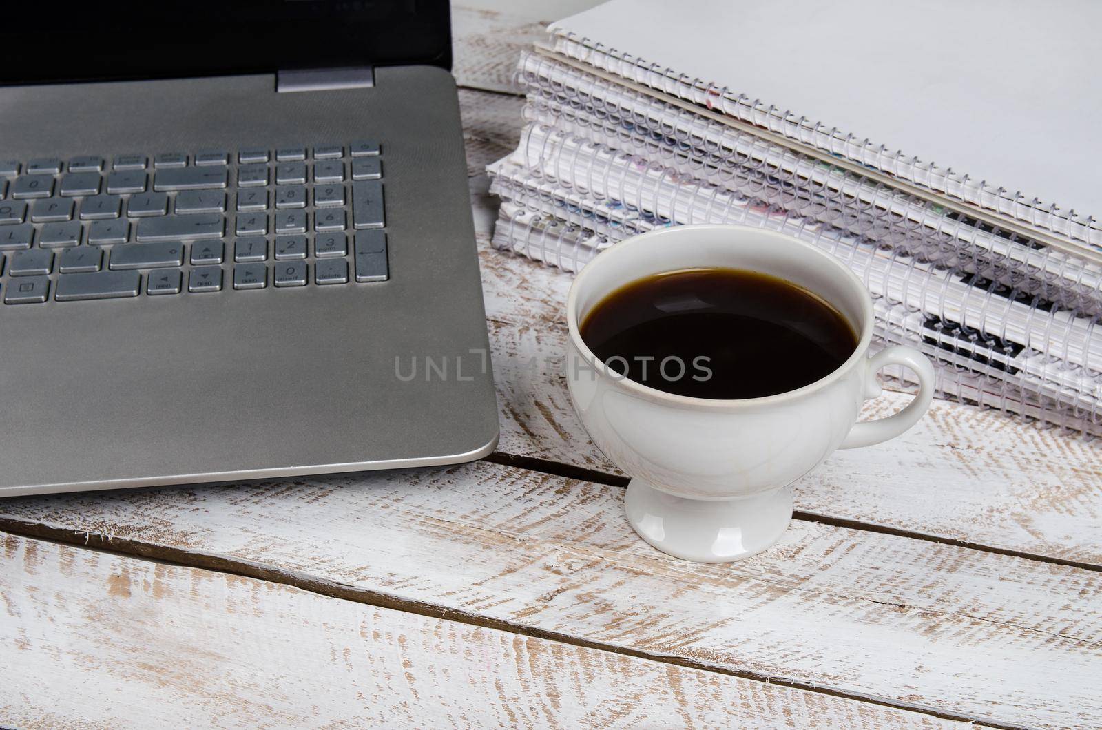 Coffee table with laptop and notebook by Jyliana