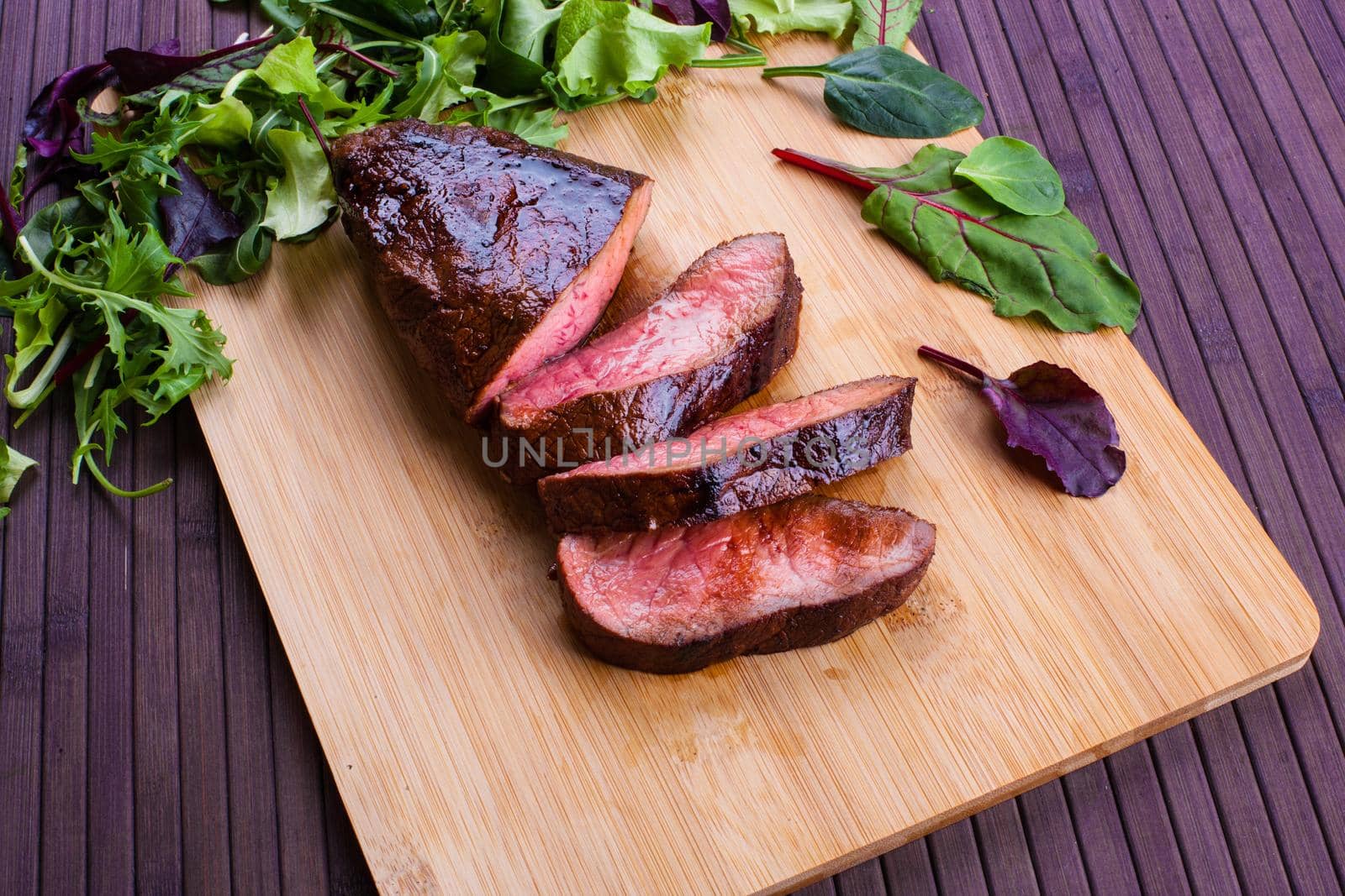 Beef grilled with blood on the kitchen blackboard. Stock image.