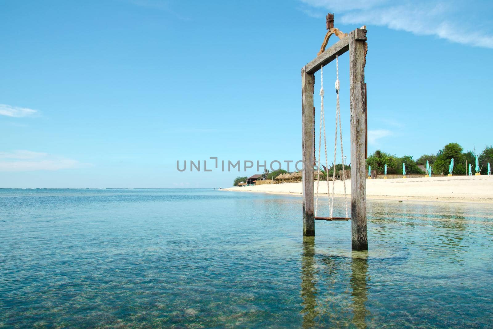 Bali, Indonesia. Exotic beach. Swing located in the ocean near the island of Gili. Stock Image