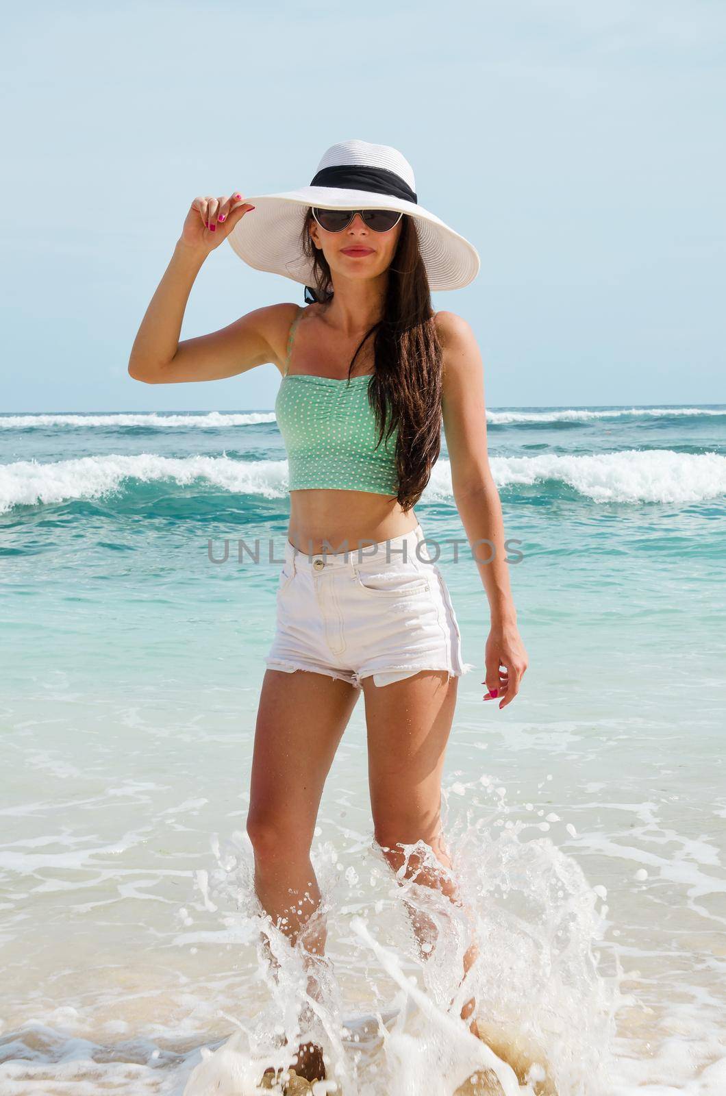 Young woman on beach - Stock image by Jyliana