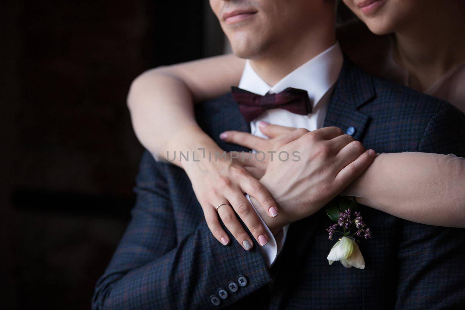 Wedding couple holding hands and hugging. Stock image.