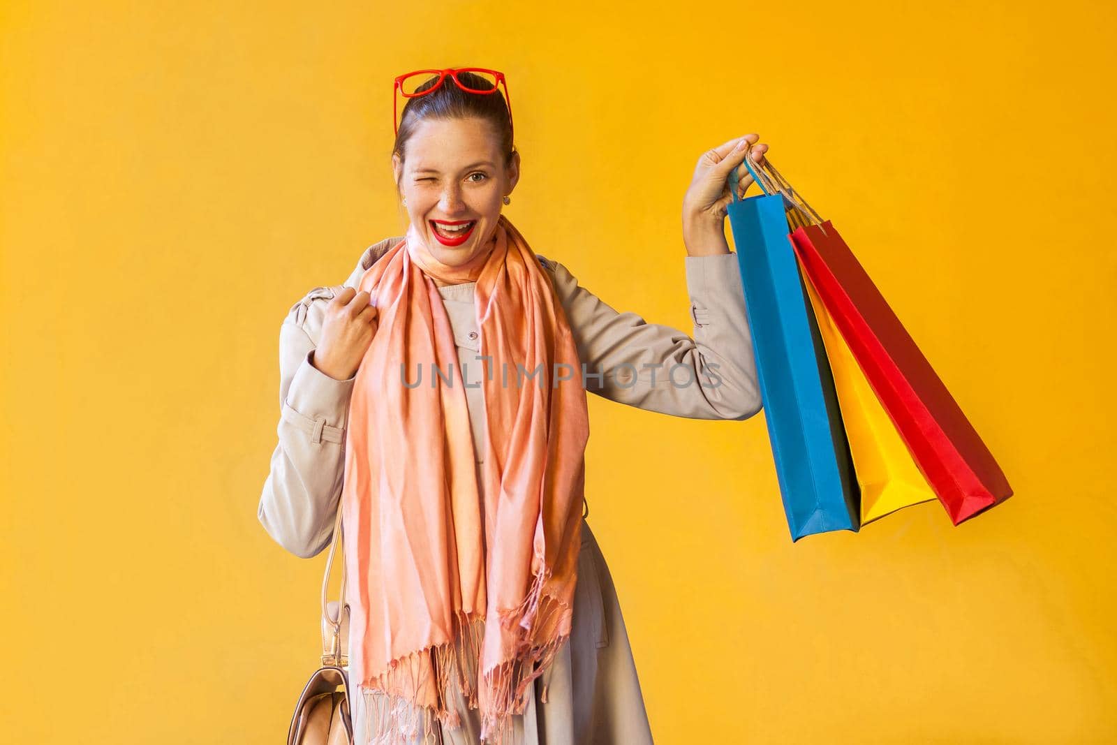 Toothy smiling, wink and flirt and camera and and holding colorful packets. by Khosro1