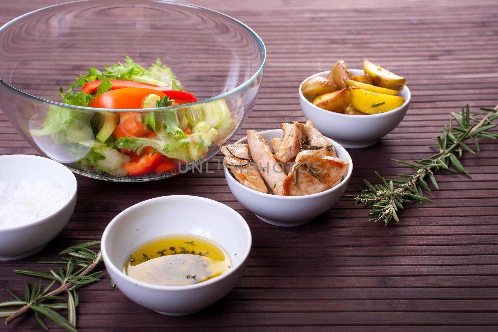 Ingredients for vegetable salad with chicken breast on a plate. Stock image.