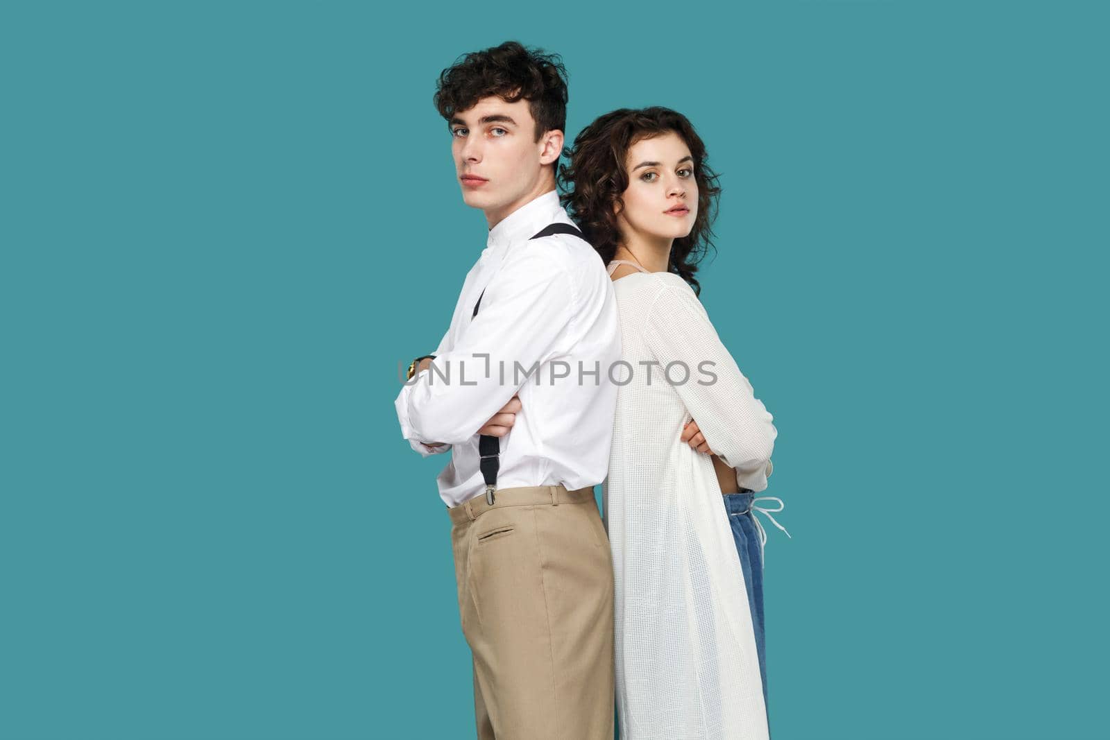young couple standing on blue background. by Khosro1