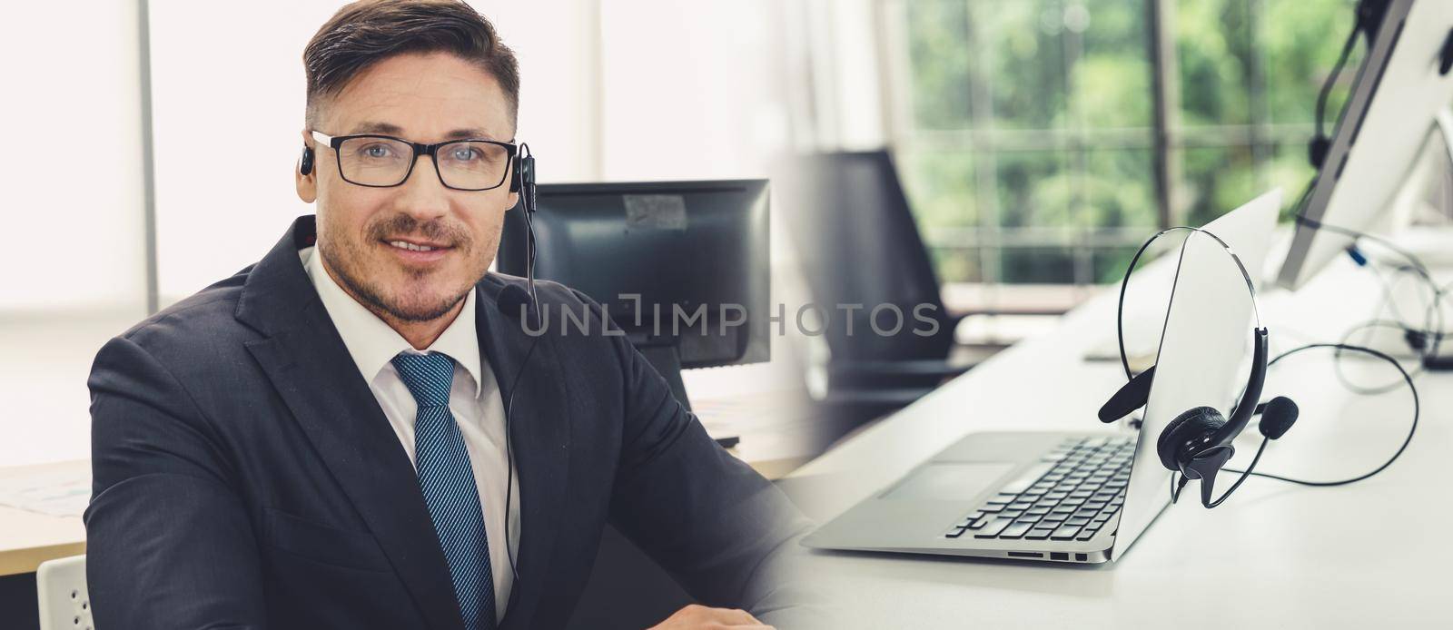 Business people wearing headset working in office to support remote customer or colleague. Call center, telemarketing, customer support agent provide service in broaden view .