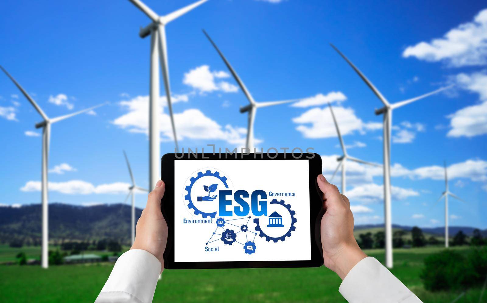Green business transformation for environment saving and ESG business concept. Businessman using tablet to set corporate goal toward environmental friendly management and alternative clean energy use.