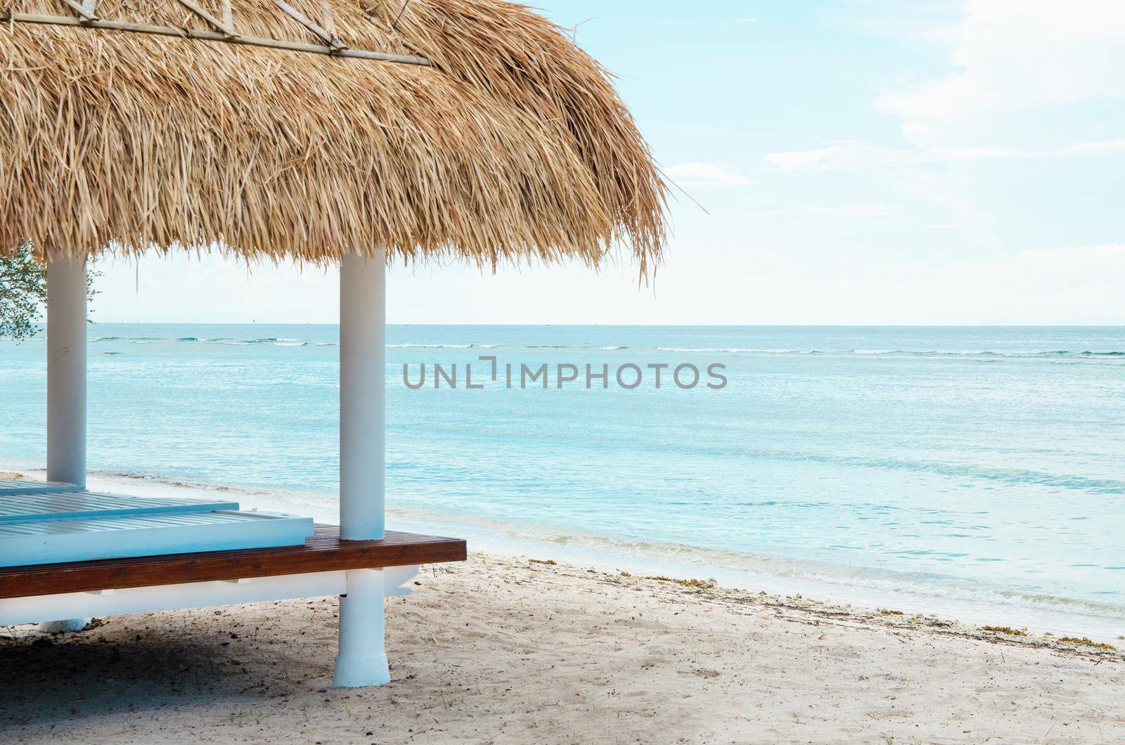 White wooden shelter from the sun on the beach in Bali. Stock image.