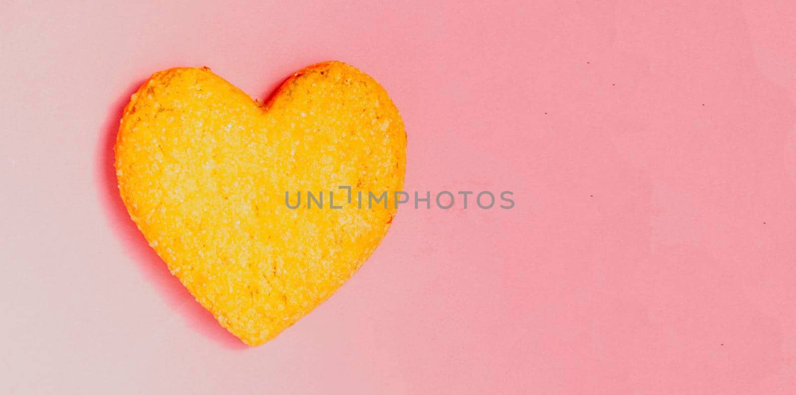 Valentine day.The cookie in shape heart on pink background.Top view,flatlay