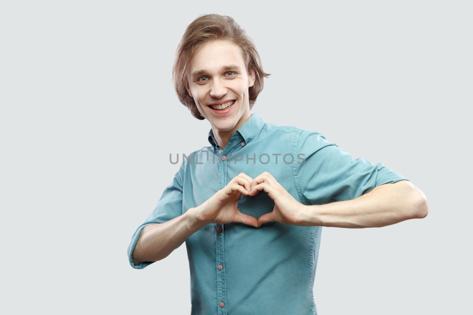 Emotional young man standing on gray background. by Khosro1