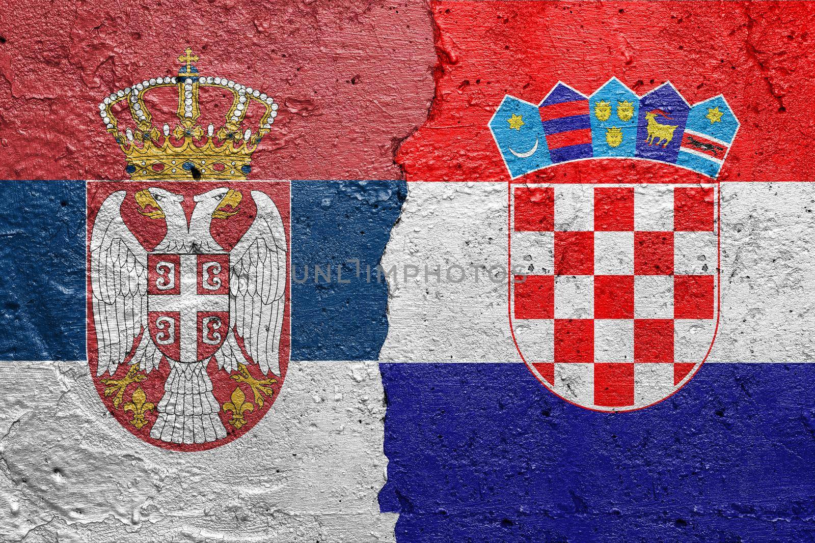 Serbia and Croatia - Cracked concrete wall painted with a Serbian flag on the left and a Croatian flag on the right stock photo by adamr