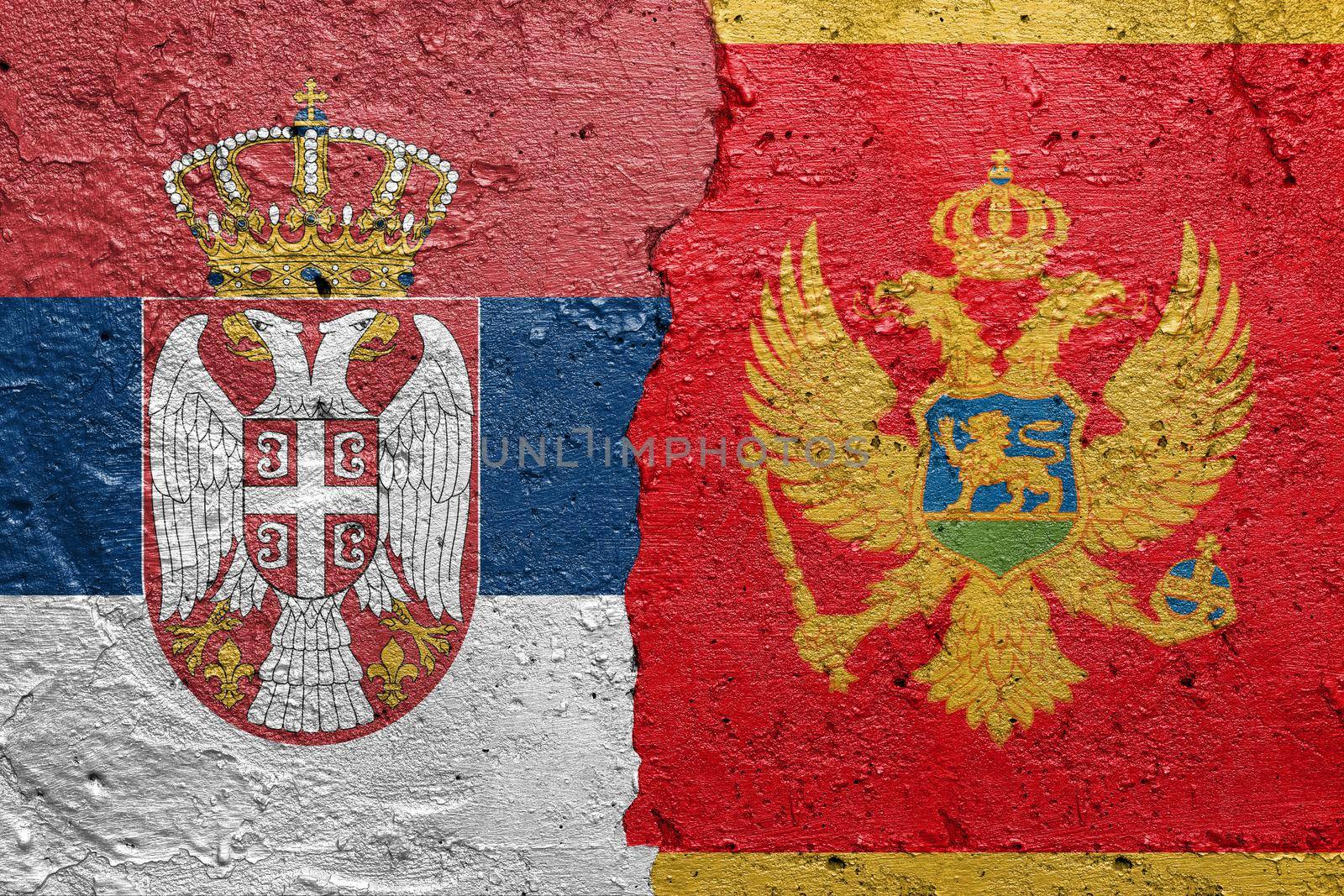 Serbia and Montenegro - Cracked concrete wall painted with a Serbian flag on the left and a Montenegrin flag on the right stock photo by adamr