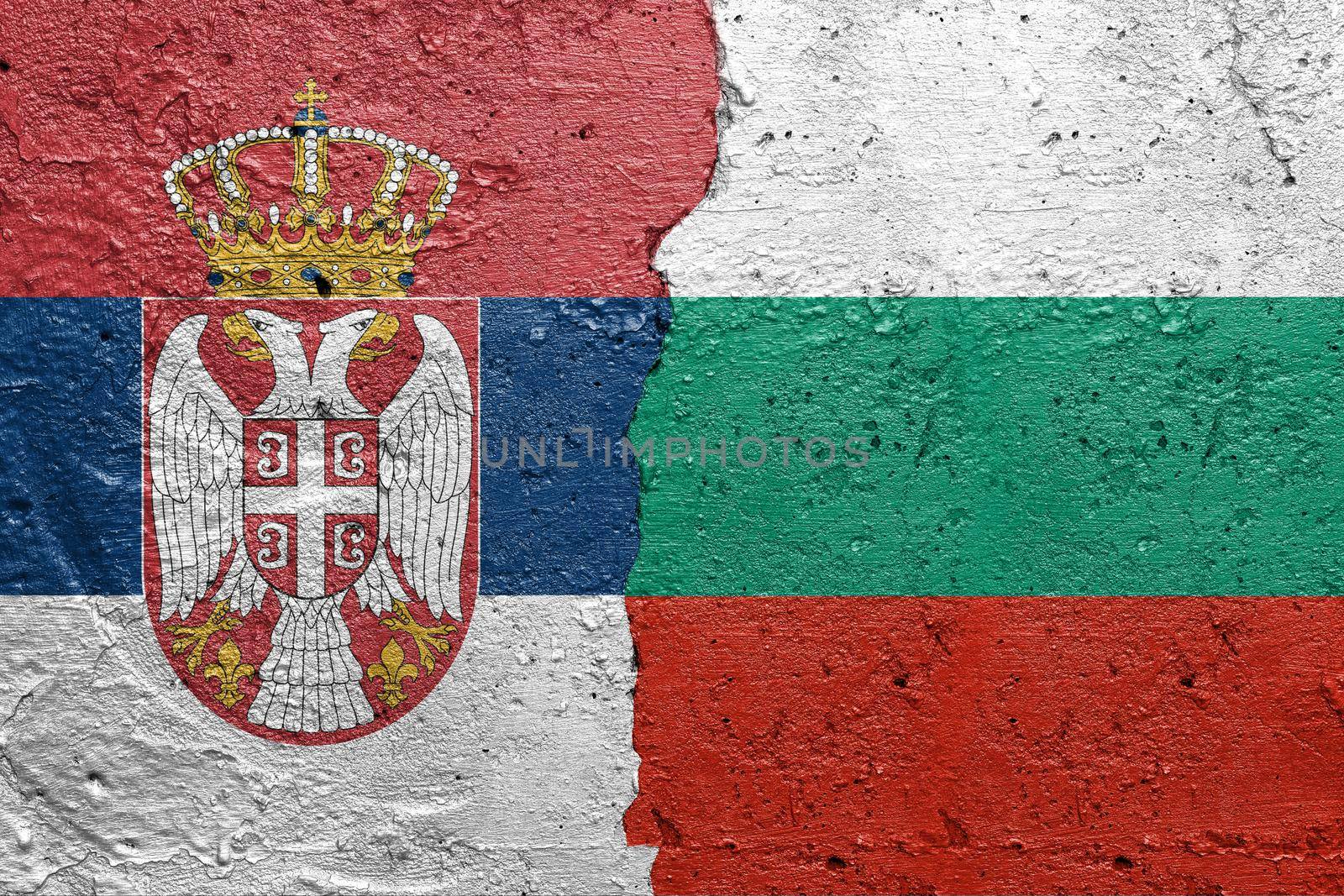 Serbia and Bulgaria - Cracked concrete wall painted with a Serbian flag on the left and a Bulgarian flag on the right stock photo by adamr