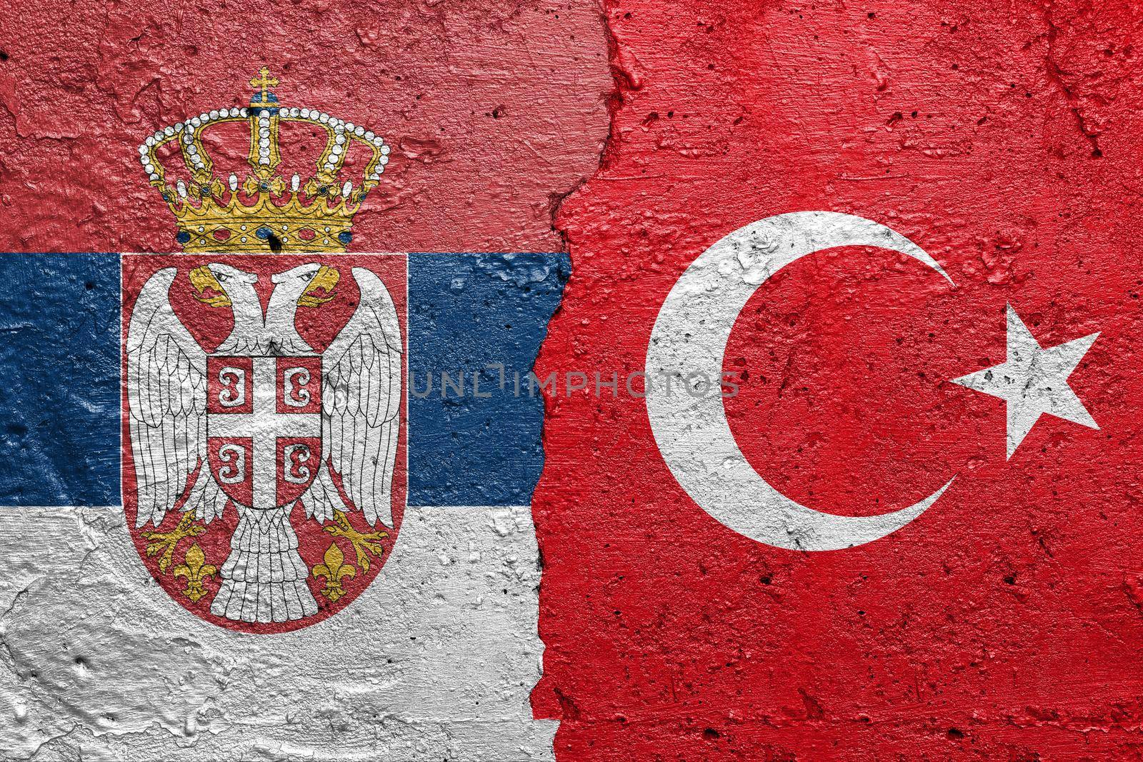 Serbia and Turkey flags  - Cracked concrete wall painted with a Serbian flag on the left and a Turkish flag on the right