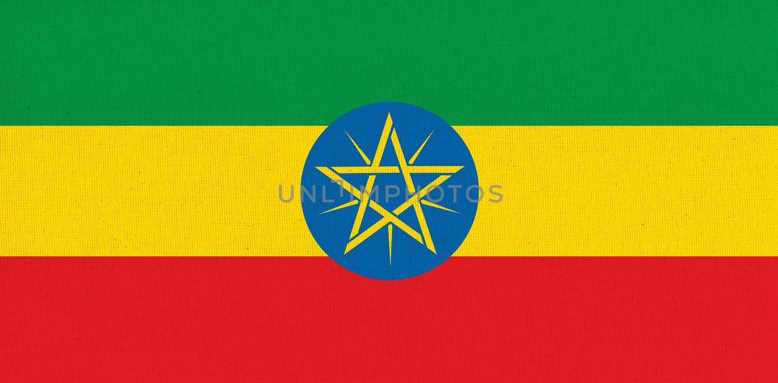Flag of Ethiopia. flag of African country Ethiopia on fabric surface. Fabric texture. National symbol of Ethiopia on patterned background. Federal Democratic Republic of Ethiopia