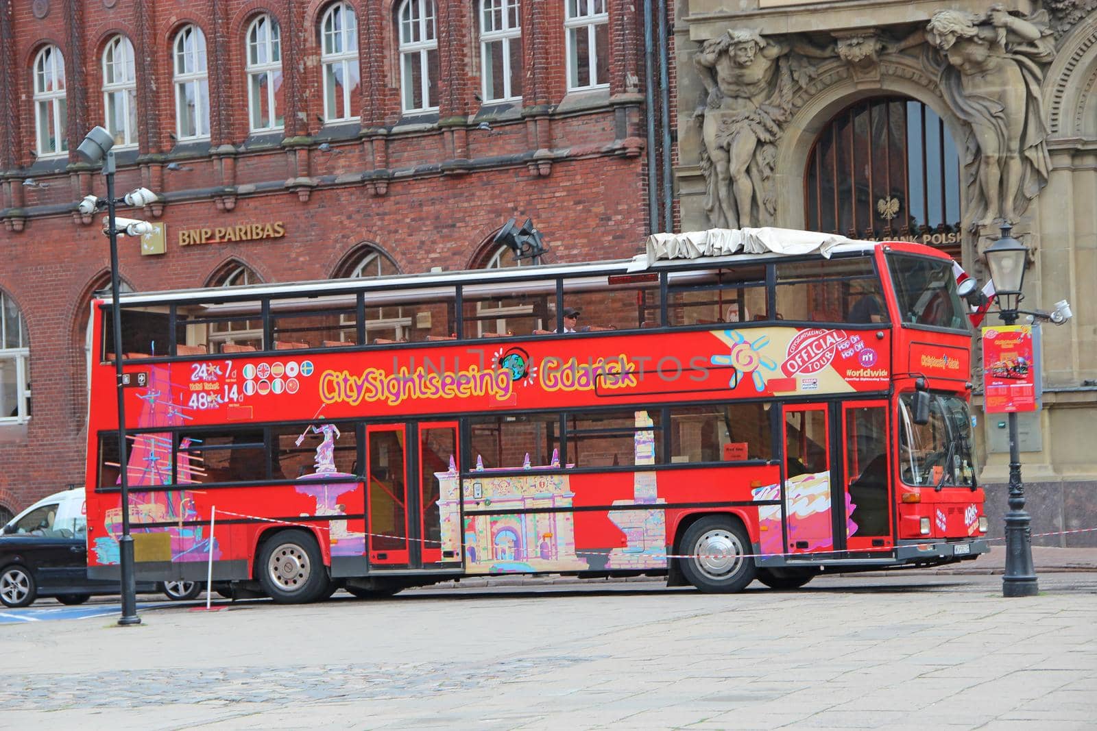 Double-decker red bus for city tours in Gdansk. Modern bus riding around city. by alexmak