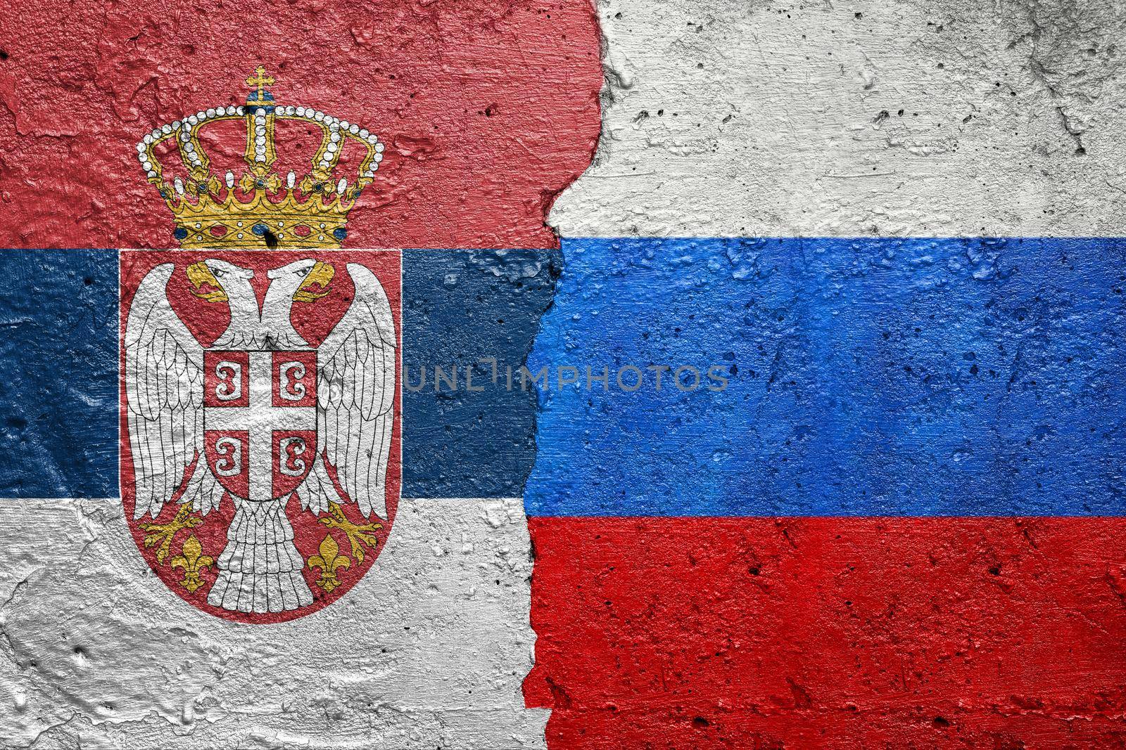 Serbia and Russia flags  - Cracked concrete wall painted with a Serbian flag on the left and a Russian Federation flag on the right