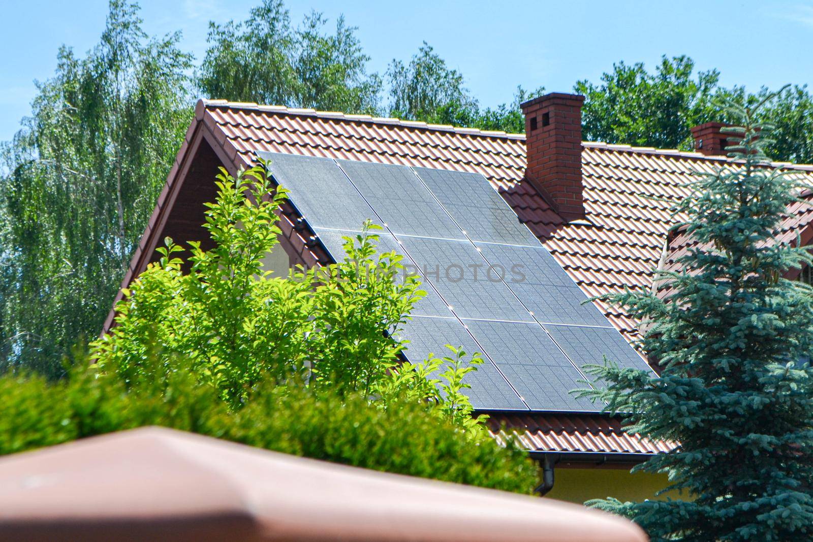 Historic farm house with modern solar panels on roof and wall High quality photo