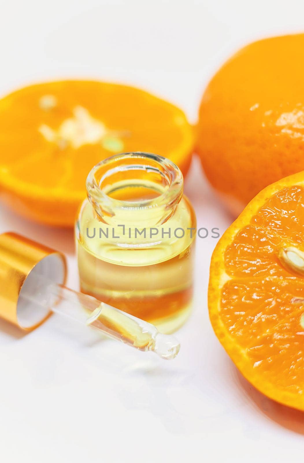 Orange essential oil on a white isolated background. Selective focus. food.