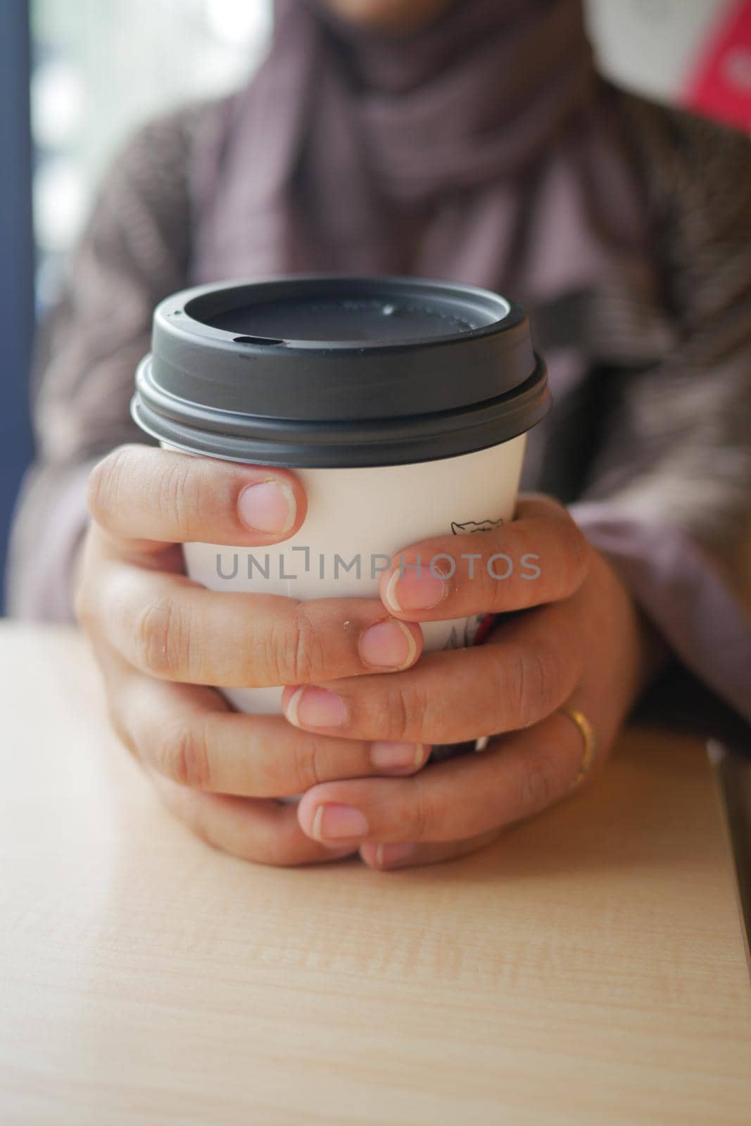 women holding a take away paper coffee cup ,