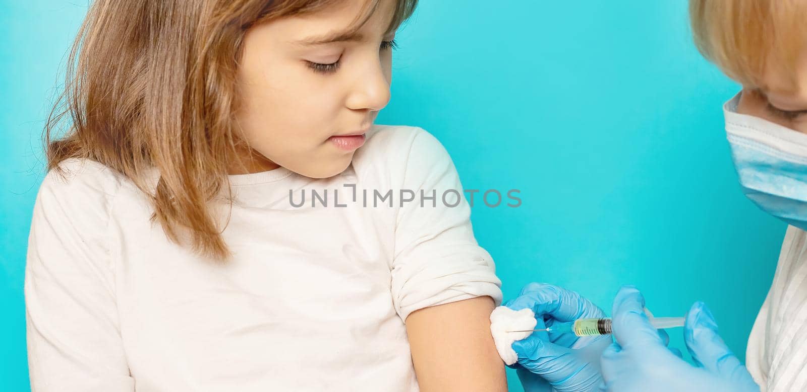 The child is injected into the arm. Selective focus.