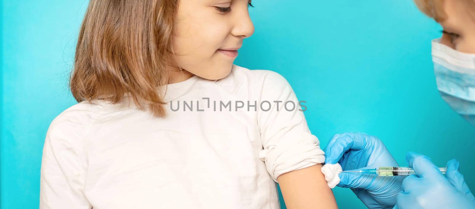 The child is injected into the arm. Selective focus.