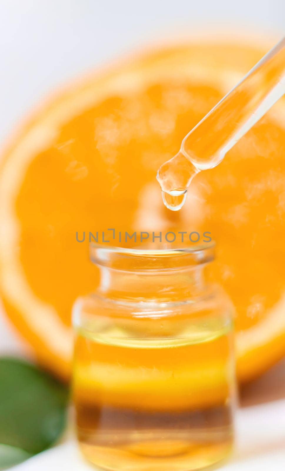 Orange essential oil on a white isolated background. Selective focus. food.