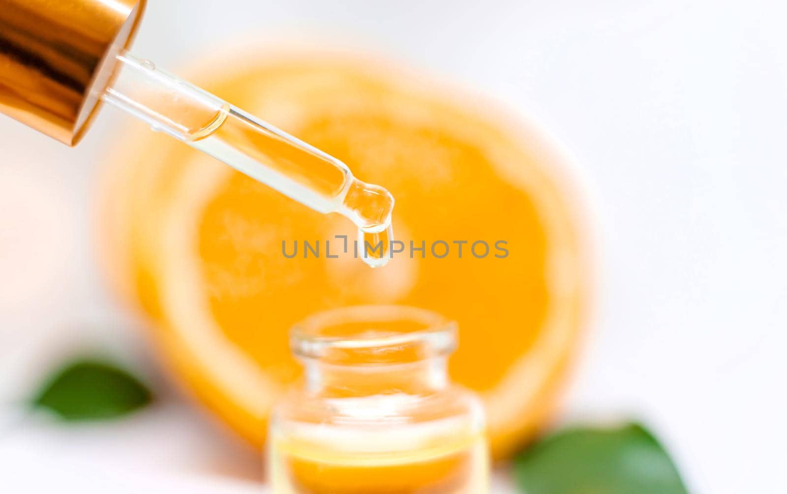 Orange essential oil on a white isolated background. Selective focus. food.