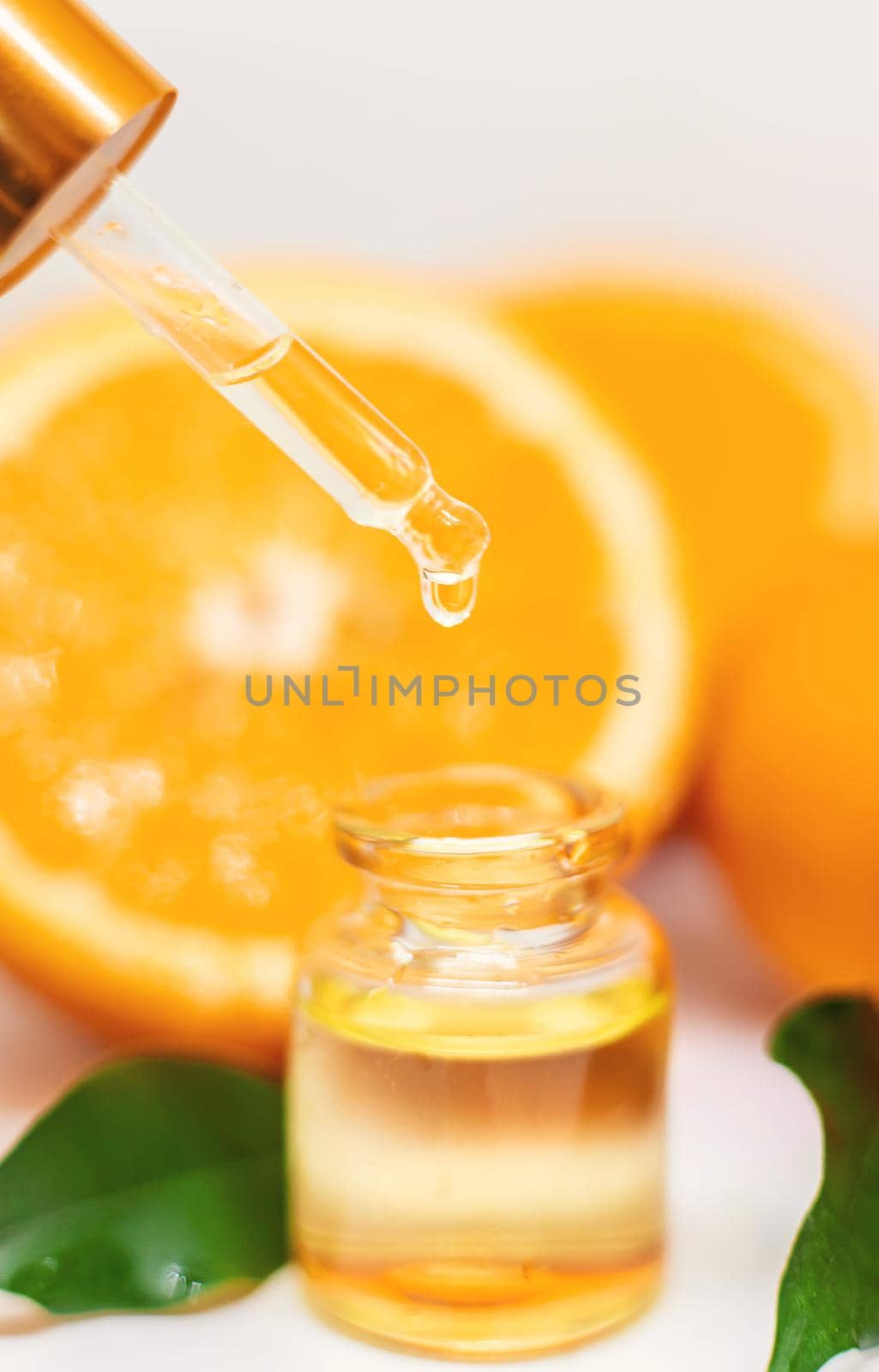 Orange essential oil on a white isolated background. Selective focus. food.