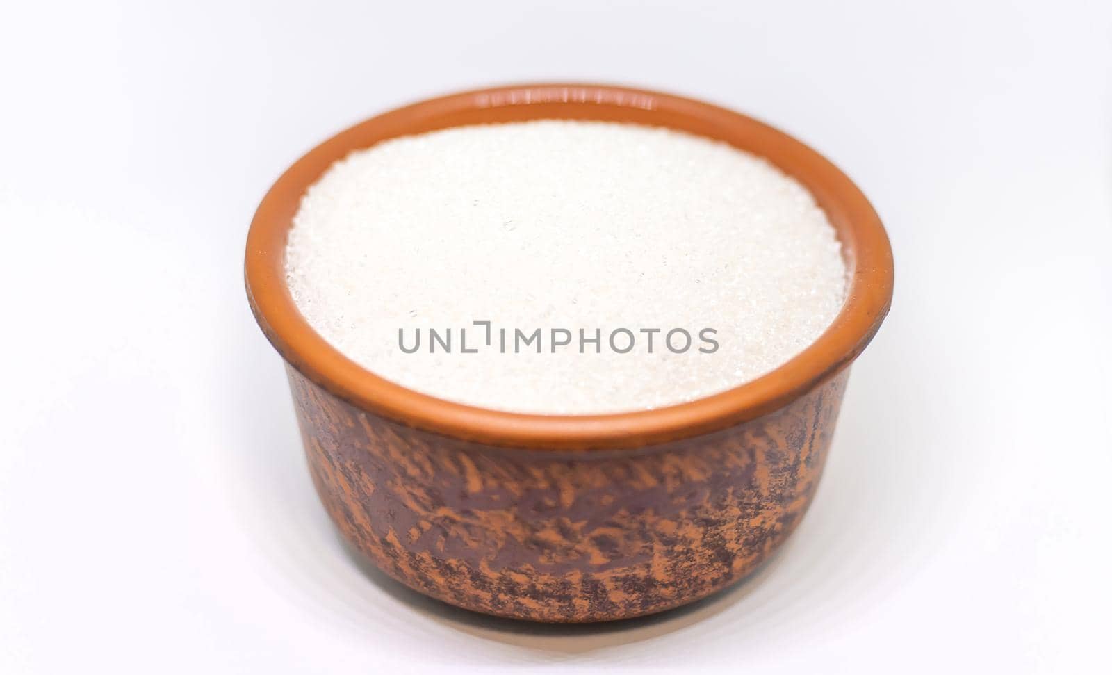 White sugar on a white isolated background. Selective focus. by yanadjana