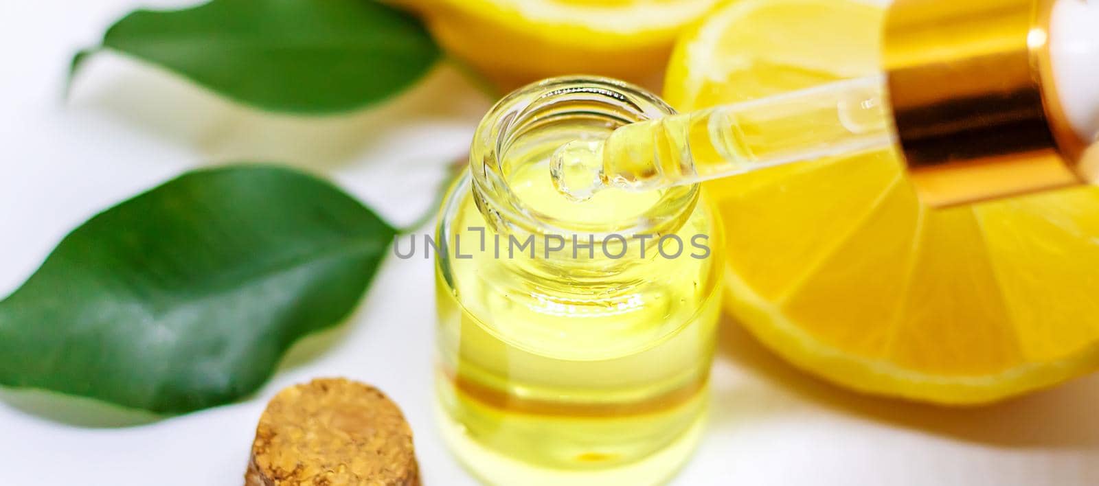 Lemon essential oil on a white isolated background. Selective focus. Food.