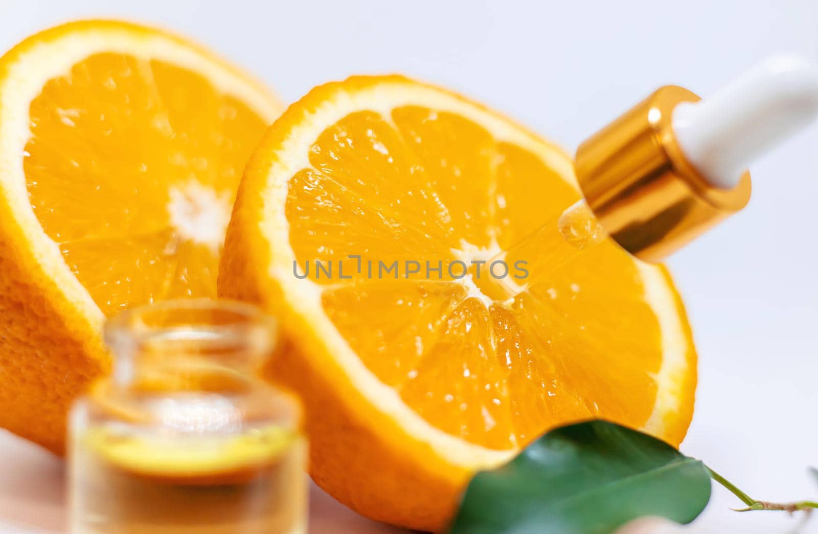 Orange essential oil on a white isolated background. Selective focus. food.