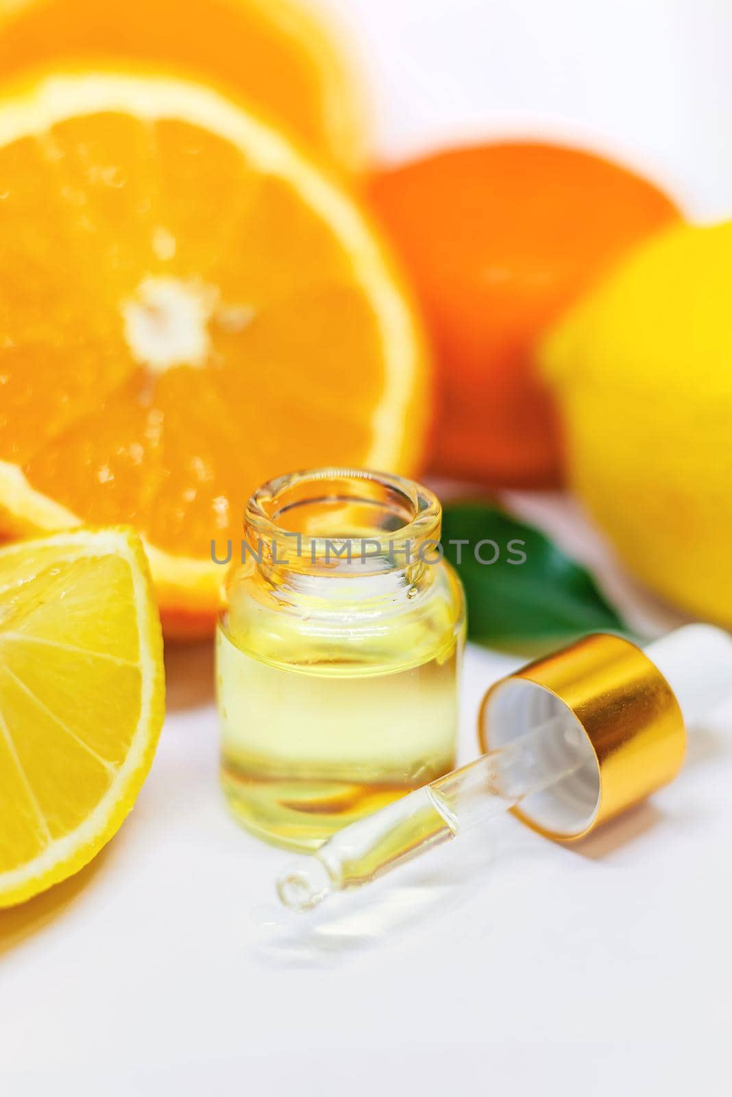 Orange essential oil on a white isolated background. Selective focus. food.