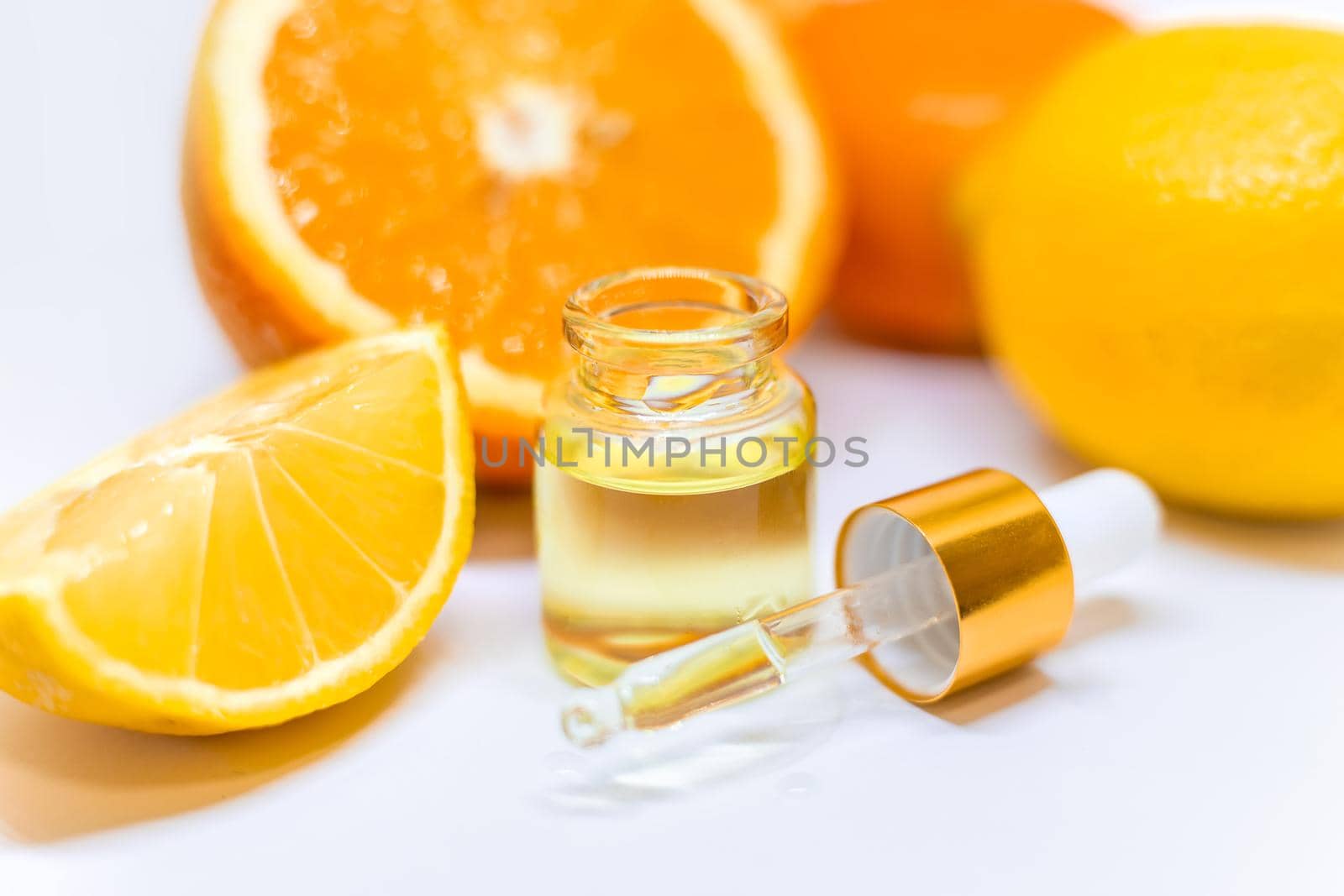 Orange essential oil on a white isolated background. Selective focus. food.