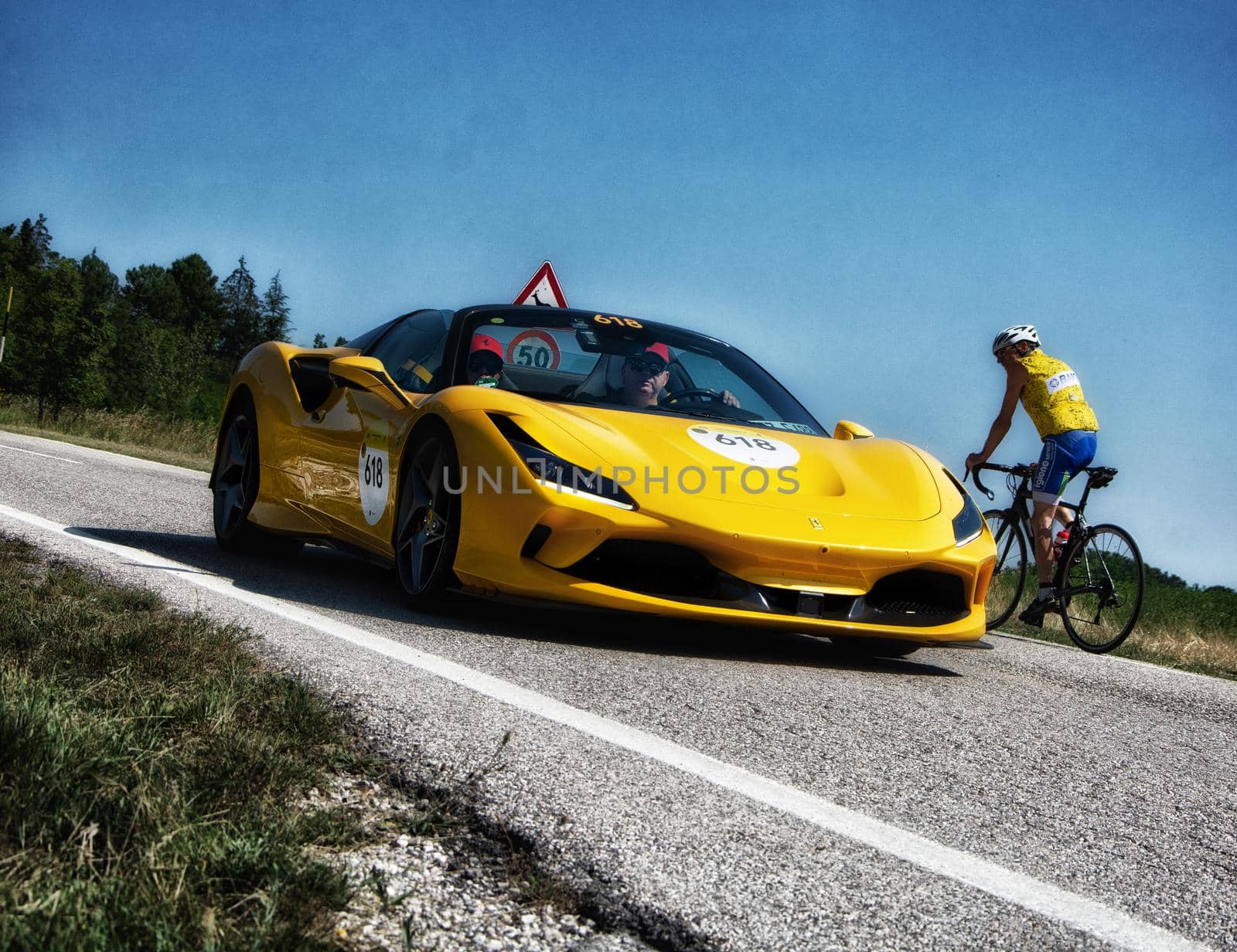 URBINO, ITALY - JUN 16 - 2022 : FERRARI TRIBUTE Ferrari F8 Spider IN an old racing car in rally Mille Miglia 2022
