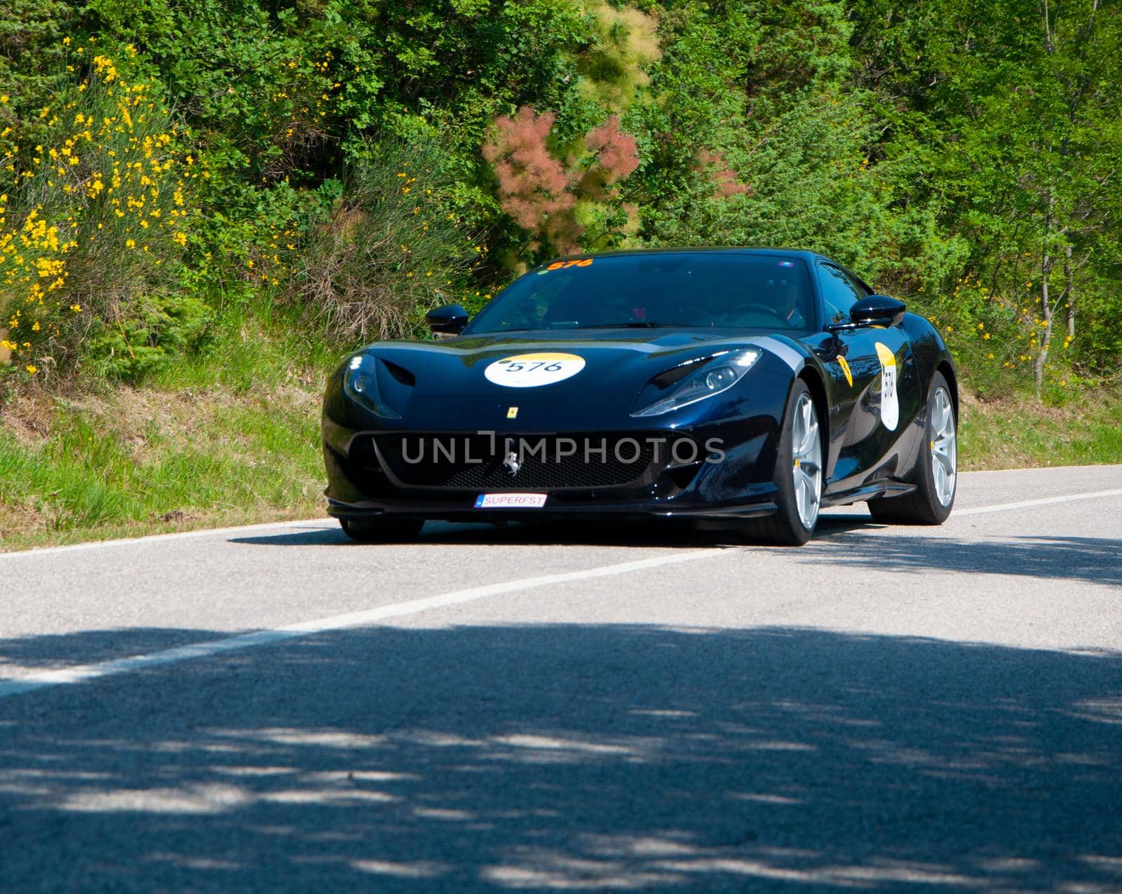 URBINO, ITALY - JUN 16 - 2022 : FERRARI TRIBUTE Ferrari 812 Superfast IN an old racing car in rally Mille Miglia 2022