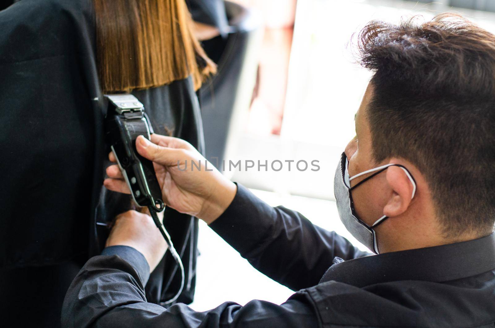 Young man and woman hairdressers in beauty salon