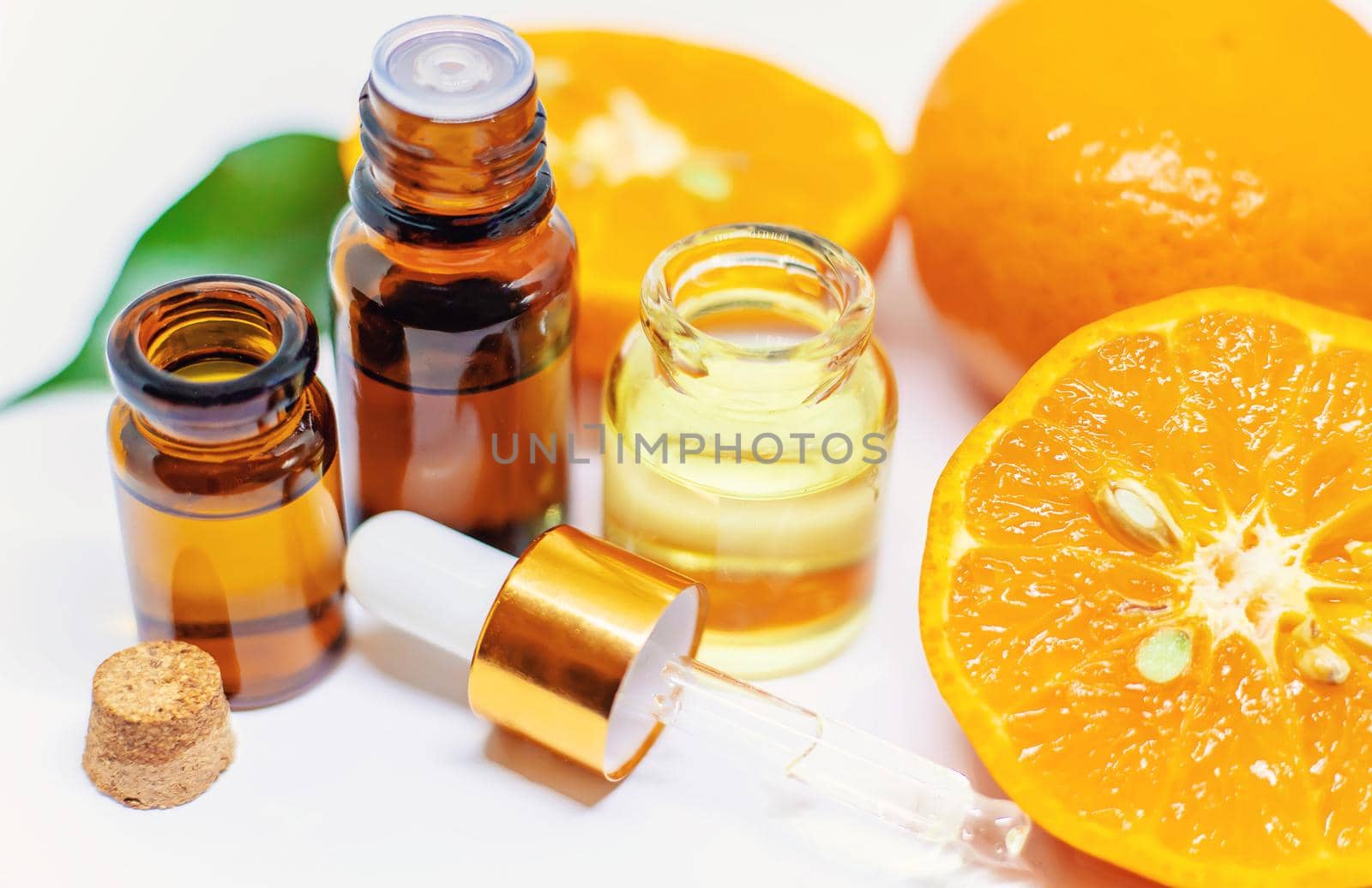 Orange essential oil on a white isolated background. Selective focus. food.