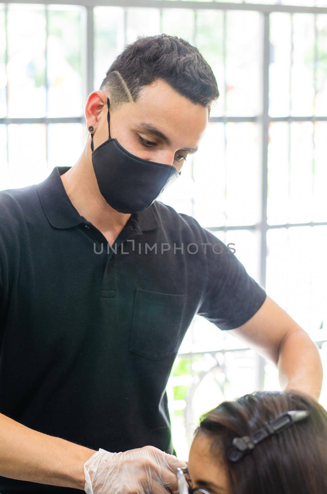 Young man and woman hairdressers in beauty salon