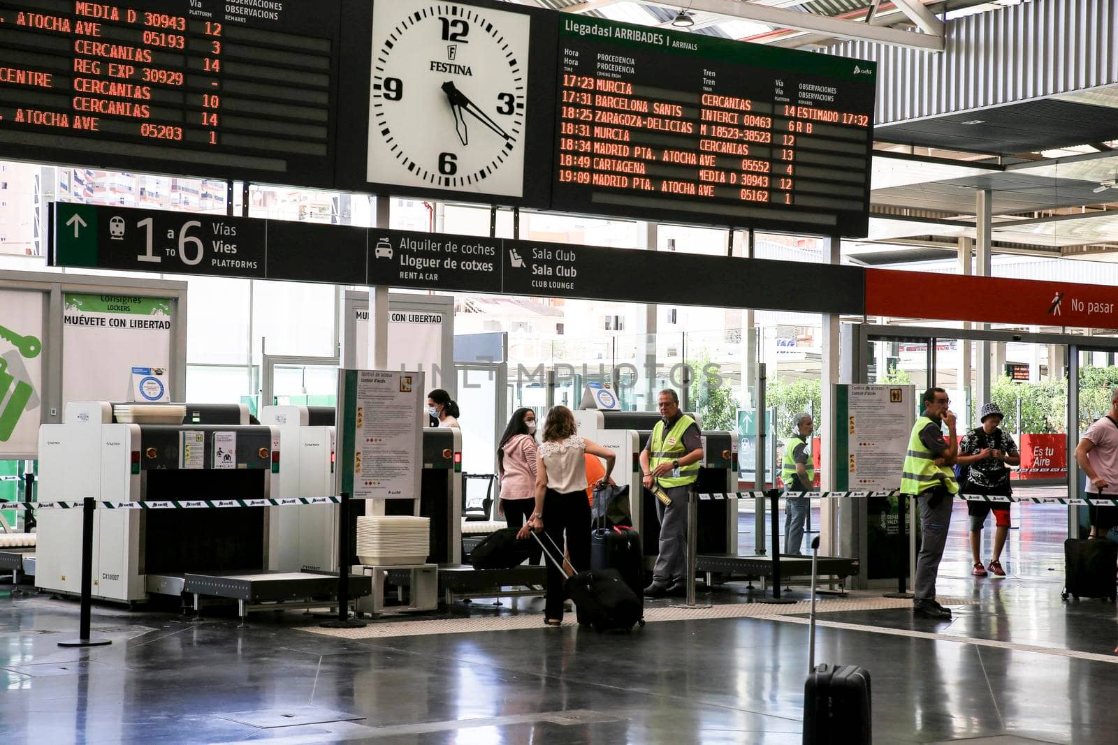 Alicante, Spain- June 24, 2022:Passengers walking through the train station of Alicante with suitcases