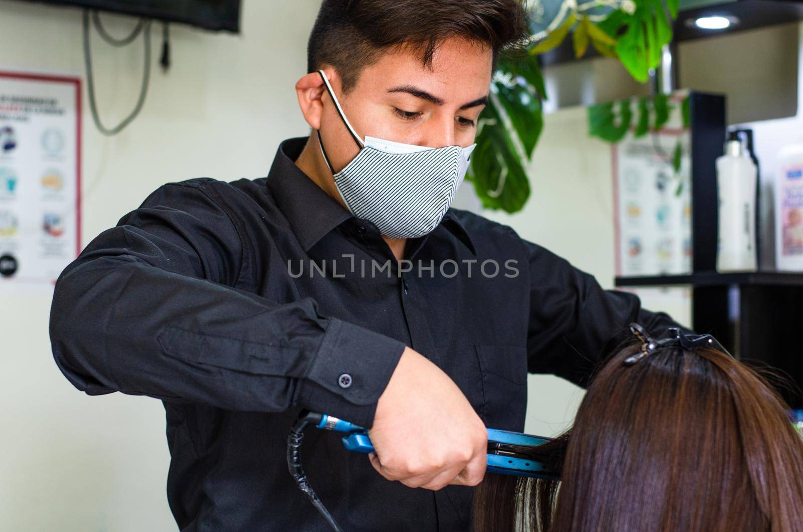 Young man and woman hairdressers in beauty salon. by Peruphotoart