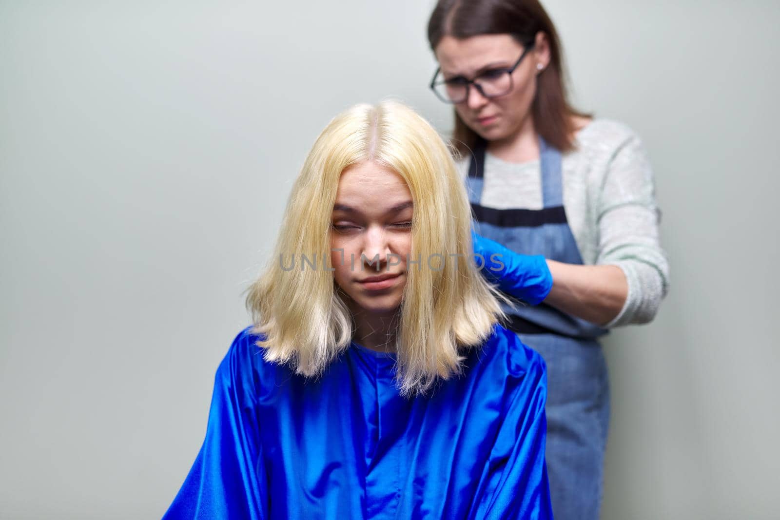 Hair coloring at home, mom dyes her daughter's hair, teenage girl and parent, beauty, family, quarantine concept