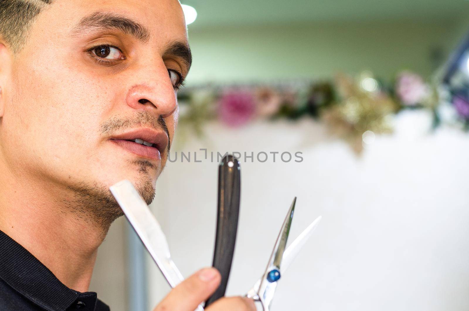 Barber Shop. Barber holds a razor to shave his beard. Boy with vintage razor.