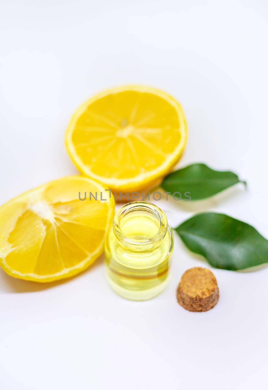 Lemon essential oil on a white isolated background. Selective focus. Food.