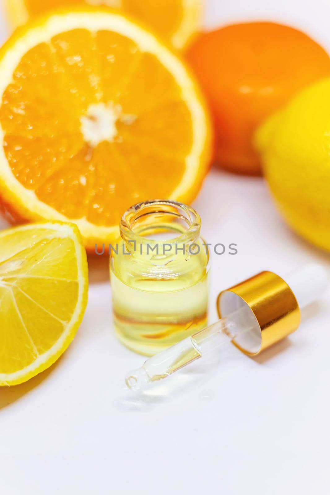 Orange essential oil on a white isolated background. Selective focus. food.